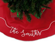 a christmas tree skirt with the words, the smiths written in white on it