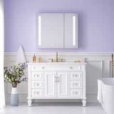 a bathroom with purple walls and white furniture