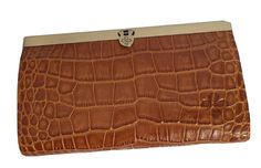 Patricia Nash Cauchy Croco Embossed Leather Frame Wallet-Cognac-NWT-Orig. Price $119.00                          NEW HAS ORIGINAL TAG Color : Cognac Croco Size/Profile: Bi-fold, rectangular wallet Walls: Genuine leather deep-embossed grape leaf logo Hardware: antiqued metal Construction: Heavy stitching Closure: Metal frame top with push lock Lining: Leather interior with nylon lining Interior: Zipper pocket, 4 bill slip pockets and 10 credit card slots RFID protection Size & Content Measurements: Approx. 7.5"L x 1.125"W x 4.375"H Shell: 100% leather Elegant Brown Clutch With Coin Pocket, Brown Textured Leather Clutch For Formal Occasions, Formal Brown Textured Leather Clutch, Elegant Brown Textured Leather Wallet, Brown Clutch Wallet For Formal Occasions, Luxury Brown Bifold Clutch, Formal Brown Clutch Wallet, Brown Bifold Clutch For Formal Occasions, Leather Frame