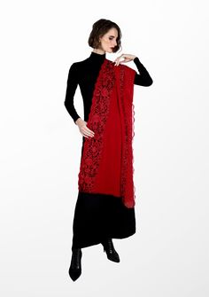 Crafted from a premium blend cashmere , this red scarf offers the perfect fusion of warmth and luxury. A vibrant masterpiece adorned with exquisite floral Gara embroidery and filigree lace panels on the long borders. The dual-colored black and red floral embroidery brings an elegant touch, reminiscent of nature's beauty, while the floral filigree lace enhances the scarf's delicate charm. The deep red color exudes a sense of passion making this scarf suitable for various occasions. Whether you ch Red Embroidered Pashmina Shawl, Elegant Embroidered Red Pashmina Shawl, Elegant Red Pashmina Shawl In Traditional Drape, Elegant Red Shawl With Traditional Drape, Elegant Red Pashmina Shawl, Elegant Scarf With Traditional Drape For Winter, Elegant Scarves With Traditional Drape For Winter, Elegant Winter Scarves With Traditional Drape, Festive Red Pashmina Shawl With Intricate Embroidery