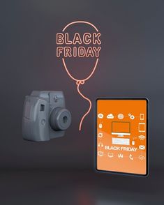 a black friday sale with a digital camera and neon sign on the wall next to it