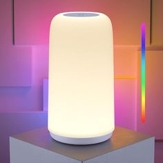 an electronic device is sitting on top of a box with colored lights in the background