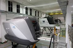 an airplane sitting on top of a metal platform in a garage next to other vehicles