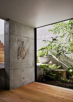 the interior of a modern house with wood floors and stairs leading up to an outdoor area