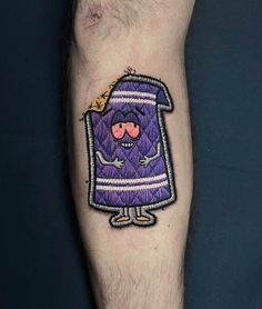 a man's arm with a purple cartoon character tattoo on the left side of his leg