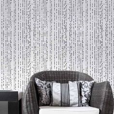 a white couch sitting next to a black and white wall