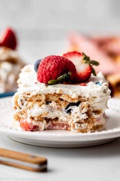 a piece of cake on a plate with strawberries