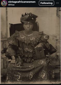 an old black and white photo of a woman sitting in a chair with a hat on her head