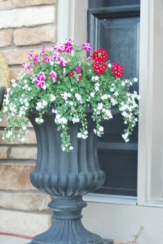 a vase filled with flowers sitting on top of a window sill next to a door