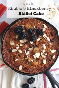 a skillet cake topped with blackberries and almonds