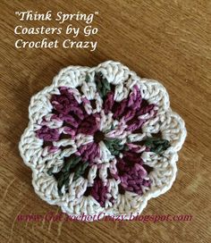 a crocheted flower on top of a wooden table with text that reads think spring coasters by go crochet crazy