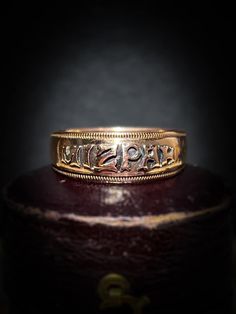 "Charming and intricately detailed antique 'Mizpah' ring crafted in buttery 9ct rose gold, the lettering vividly stands out over a sleek background Throughout the Victorian era, the process of engraving rings with the word \"MIZPAH\" was adored and lovingly gifted between two sweethearts.  'Mizpah' which is Hebrew for watchtower signifies an emotional bond between two people. The meaning of the word is loosely interpreted as \"May God watch over you,\" it is with the intention that the piece is to be gifted as a token of  love or friendship. The rosy coloured band is sleek allowing for the bold ''Mizpah'' letters to really stand out from its background and a textured design borders the rings edge, the ring has crisp antique hallmarks which are an added bonus The original purpose of this be Ceremonial Antique Rings With Antique Finish, Antique Etched Rings For Ceremonial Occasions, Antique Engraved Filigree Ring For Ceremonial Occasions, Antique Engraved Ring With Intricate Design, Antique Engraved Ring With Decorative Band, Antique Hallmarked Filigree Ring For Ceremonial Use, Antique Engraved Ring With Intricate Design For Ceremonial Use, Traditional Ceremonial Engraved Ring With Decorative Band, Antique Ceremonial Ring With Intricate Design