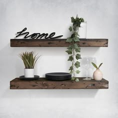 two wooden shelves with plants and plates on them, along with the word home written in black