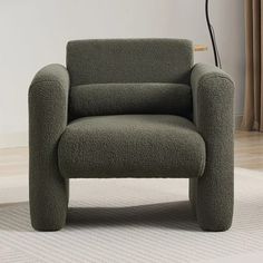 a green chair sitting on top of a white rug