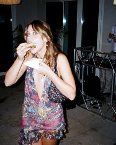 a woman in a short dress eating food