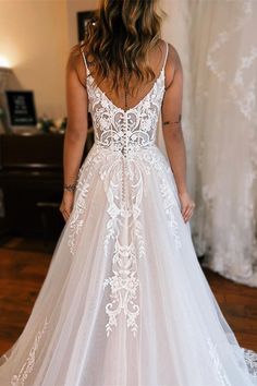 a woman in a white wedding dress looking back