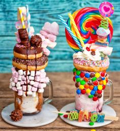 three different kinds of donuts on plates with candy and lollipops in them