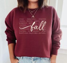 Fall with words sweatshirt.   Available in variety of colors, sizes and lettering colors.   Sweatshirt shown in listing photos is Maroon, with cream and white lettering (scroll through photos to see each color).  Ash sweatshirt is shown with Brown, Maroon and Black Lettering. Gildan Brand sweatshirt is Unisex (Men's fit) so it runs on the larger side for women-Please see size chart.   Adult shirts only available in this style.   Shirt Colors may vary slightly - depending on your screen. If shirt color or size that you order is unavailable-I will message you to select another color.  If we cannot come up with a solution, I will refund you. (Please keep mind that the black vinyl will not show up well on some dark shirt colors, the white shows up well on most colors.)  To Order: 1. Choose Swe Orange Sweatshirt, Fall Orange, Fall Stuff, Create Shirts, Adulting Shirts, Fall Sweatshirt, Branded Sweatshirts