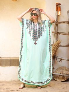 An elegant and stylish caftan will make you feel like African royalty. It's extremely elegant with a dash of colorful cotton embroidery adorning the kaftan. Ideal for plus size women as well. Made of extremely soft fabric to make you feel free and beautiful at the same time.  This Kaftan is ideal to wear for any casual occasion. Whether taking a trip down the shopping lane, or home-based kitty parties, or about anything else, wearing this dress will make you feel classy and comfortable. Fabric : Embroidered Green Kaftan, Green Embroidered V-neck Kaftan, Green Bohemian Abaya With V-neck, Bohemian Green V-neck Abaya, Green Long Embroidered Kaftan, Green Kaftan For Vacation And Eid, Green Kaftan For Eid Vacation, Green Embroidered Bohemian Style Abaya, Bohemian Green Embroidered Abaya