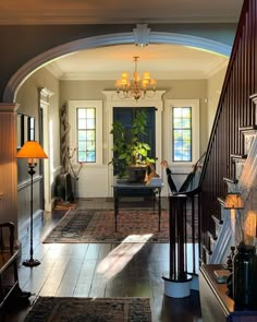 an archway leads to the living room and dining room in this elegant country style home