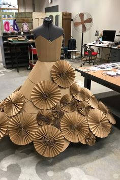 a dress made out of brown paper sitting on top of a table