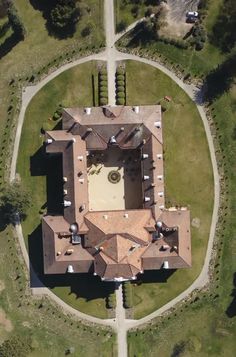 an aerial view of a large house in the middle of a park