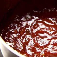 a pot filled with sauce sitting on top of a stove