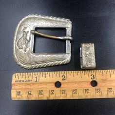 "A set of 3 silver tone metal southwestern/cowboy style belt buckle parts. I'll do my best to describe these but I have to admit that I know nothing about using these to ornament a belt. I just fell in love with the color and details on these pieces. I also am not able to identify the metal. All three definitely look vintage, have wear, and have tarnished over time. Please refer to the photo numbers for the measurements given below: Photo #3 Belt Buckle - There's a small circle with the head of Adjustable Silver Belt Buckles For Rodeo, Silver Belt Buckles For Rodeo, Silver Western Belt Buckles, Adjustable Silver Belt Buckles For Western-themed Events, Silver Antique Belt Buckles For Western-themed Events, Vintage Silver Belt Buckles For Rodeo, Western Silver Belt With Buckle Closure, Adjustable Silver Southwestern Belt Buckles, Vintage Silver Belt Buckle For Rodeo