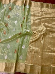 Beautiful Pista Green color Linen Soft Silk Saree with Weaved Buttas all over. Saree is super light weight and very Stable. Copper and Sliver Buttas on the body of the Saree while the Border and Pallu is Matt Gold. Please note - Since the material is tissue, it might looks lighter in shade in sunlight and darker in room-light specially in yellow light. Item : SareeColor : Pista GreenBase Fabric : Linen Soft Tissue Silk Blouse piece : YesBlouse material : Linen Soft Tissue Silk Transparent (Yes/N Festive Slub Silk Saree With Sheer Dupatta, Transitional Pista Green Chanderi Traditional Wear, Festive Pista Green Cotton Silk Traditional Wear, Pista Green Slub Silk Dupatta With Cutdana, Pista Green Slub Silk Traditional Wear For Diwali, Festive Pista Green Raw Silk Blouse Piece, Green Traditional Wear With Zari Weaving For Celebration, Transitional Pista Green Chanderi Blouse Piece, Green Tissue Silk Dupatta