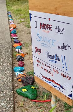 a sign that has been placed on the side of a road with shoes lined up next to it