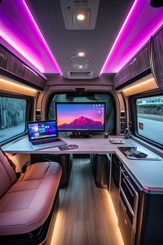 the interior of a vehicle with two monitors and laptops