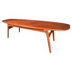 a wooden surfboard sitting on top of a table