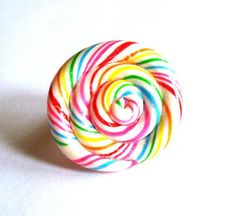 Those giant Rainbow lollipops that you get at amusement parks and carnivals have always possessed that magical and whimsical quality. I made this huge (about 1.25" across) rainbow lollipop ring from polymer clay, glazed it with a shimmer / sparkle gloss, and attached it to a silver plated adjustable ring band. Love Rainbow Lollipops? I also have a matching necklace available here: https://www.etsy.com/listing/124089222/rainbow-lollipop-necklace**Made to Order** will take about 2 weeks to make be Lollipop Ring, Rainbow Lollipops, Rainbow Jewelry, Love Rainbow, Color Ring, Pastel Rainbow, Matching Necklaces, Gift Packaging, Lollipop