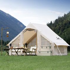 a tent set up in the middle of a field