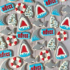 decorated cookies are arranged in the shape of shark and life preservers