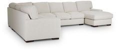 a white sectional couch sitting on top of a white floor