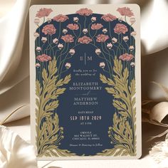 a wedding card with flowers and leaves on the front, in navy blue color scheme