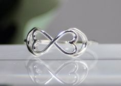 Original and beautiful. This infinity ring has been embellished with two hearts. It is completely sterling silver and a wonderful addition to any wardrobe. Visit my shop for more original items. capturedillusions.etsy.com Infinity Knot Ring, Double Heart Ring, Diamond Engagement Rings Vintage, Chevron Ring, Midi Ring, Infinity Ring, Knot Ring, Midi Rings, Double Heart