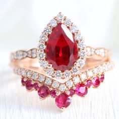 Pear-shaped Ruby Ring With Diamond For Wedding, Red Ruby Wedding Ring, Pear-shaped Ruby Diamond Ring, Pear-shaped Gold Ruby Ring With Diamonds, Luxury Pear-shaped Gold Ruby Ring, Luxury Gold Pear-shaped Ruby Ring, Unique Ruby Rings, Halo Diamond Ring Set, Tiara Diamond