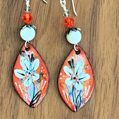 Lovely, handmade, enamel earrings like these won't last long! This pair of long orange and white enameled copper earrings is 3 inches long. Artisan made floral components are topped with round, white Jade beads, silver bead caps and orange and gray, high-end crystals. The cute, one-of-a-kind statement earrings are connected to sterling silver ear wires. The dangle earrings are perfect as a gift for her! These earrings are handmade by me, Sharon, of Blonde Peach Jewelry. They will arrive in an at Unique White Enamel Earrings, Artisan Rust-colored Earrings As Gift, White Copper Earrings As Gift, Artistic Hand Painted Copper Earrings, Handmade Rust Earrings For Gift, Handmade White Enamel Earrings, White Hand Painted Artisan Earrings, White Artisan Hand-painted Earrings, Orange Enamel Earrings Nickel Free