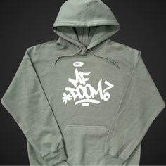 Brand New (Nwot) Mf Doom Hoodie (Military Green) With Mf Doom ? On The Front (White). Khaki Hoodie Sweatshirt For Streetwear, Khaki Drawstring Hood Top For Streetwear, Khaki Streetwear Top With Drawstring Hood, Khaki Hooded Top For Streetwear, Urban Style Khaki Cotton Hoodie, Graphic Jackets, Mf Doom, Hoodie Logo, Gildan Hoodie