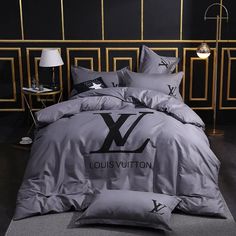 the louis vuitton bedding set is made up with grey sheets and pillows