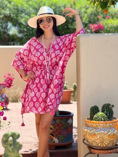 Merriam-Webster defines fanfare as a “showy, outward display.” In fact, our Fanfare Short Kaftan Dress is the perfect shade of pink to ready you for a showy, outward, display of fun and frolic. This beautiful print is made using the age old Dabu printing process. The Fanfare is block printed by hand with mud onto white fabric which is then dyed pink. The mud resists the dye and after being thoroughly washed, the fanfare design is left intact in white with a crackled effect that makes each piece Pink Printed Beachwear Dress, Pink Short-sleeved Kaftan For Summer, Pink Short Sleeve Kaftan For Summer, Pink Printed Tunic Dress, Pink Short Sleeve Beachwear Kaftan, Pink Short Sleeve Kaftan For Beachwear, Pink Short Sleeve Kaftan For Spring, Pink Printed Short Sleeve Kaftan, Pink Tunic Dress For The Beach