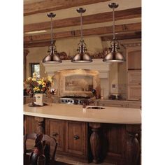 a kitchen island with three lights hanging from it's ceiling and an oven in the center