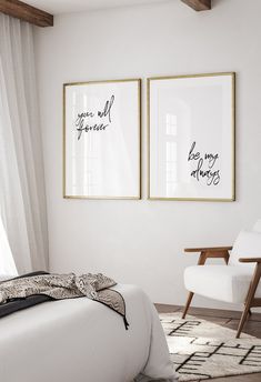 two framed pictures hang on the wall above a bed in a room with white walls