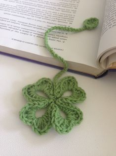 a crocheted bookmark laying on top of an open book