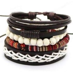 This nomadic lifestyle inspired piece is crafted with an eclectic mix of genuine leather, hand-strung beads and rich red woven cotton. Fully adjustable, this set of four bracelets can be worn all together, or mixed and matched. Worldwide Shipping Please allow 2-5 days for delivery 1081 Bohemian Brown Bracelets As Fashion Accessory, Brown Bohemian Braided Bracelet, Brown Bohemian Braided Bracelets, Bohemian Black Braided Bracelets, Multicolor Bohemian Leather Bracelet, Multicolor Leather Bracelet In Bohemian Style, Casual Brown Beaded Braided Bracelets, Bohemian Brown Woven Braided Bracelets, Red Braided Bohemian Jewelry