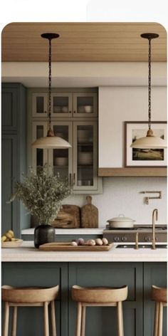 three wooden stools sit in front of a kitchen island with two hanging lights above it