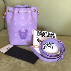 Lavender Color Mini Bucket Bag With The Head Of A Dog(French Bulldog). Heritage Artisanship Is Expressed Through The Classic Combination Of Visetos Monogram Coated Canvas And Nappa Leather. An Accompanying Leather Handle And Adjustable Leather Strap Are The Finishing Touches, Fostering Mobile Elegance. Approximately 3.9 X 5.5 X 7.9 Inches 39.5" To 46" Strap Length, Handle Drop: 4.3" Removable, Adjustable Leather Strap Leather Top Handle Leather Drawstring Closure Protective Metal Feet Nappa Leat Mini Bucket Bag, Mini Bucket Bags, Cell Phone Holster, Mini Bucket, Phone Holster, Lavender Color, Walker Boots, Fit N Flare Dress, Rain And Snow Boots