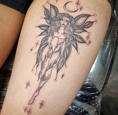 a woman's leg with a tattoo on it and a fairy holding a wand